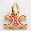 Celine Charms Triomphe in Enamel and Brass with Gold Finish Celine Charms Triomphe in Enamel and Brass with Gold Finish