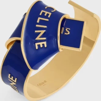 Celine Ribbon Knotted Cuff in Enamel and Brass with Gold Finish Celine Ribbon Knotted Cuff in Enamel and Brass with Gold Finish