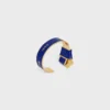 Celine Ribbon Knotted Cuff in Enamel and Brass with Gold Finish Celine Ribbon Knotted Cuff in Enamel and Brass with Gold Finish