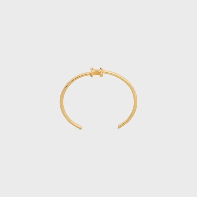 Triomphe Asymmetric Cuff in Brass with Gold Finish Triomphe Asymmetric Cuff in Brass with Gold Finish